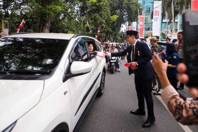 Wali Kota Medan, Rico Tri Putra Bayu Waas, bagikan bendera kepada pengendara
